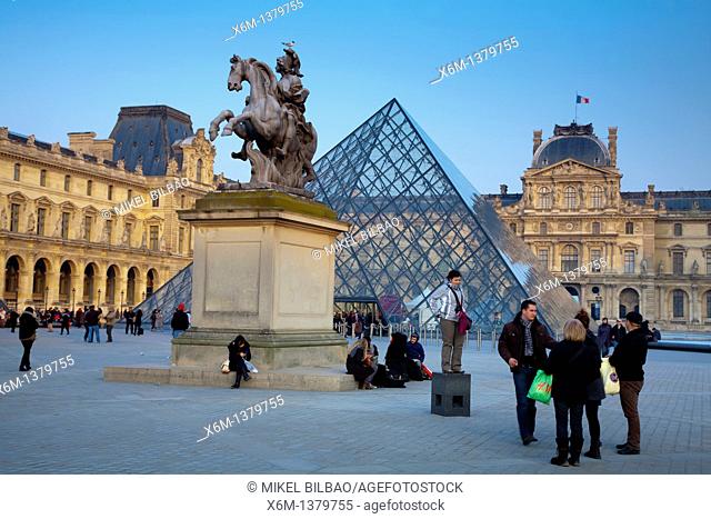 Louis XIV statue Sun King and Crystal Piramid in front of the Louvre Museum  Paris, France