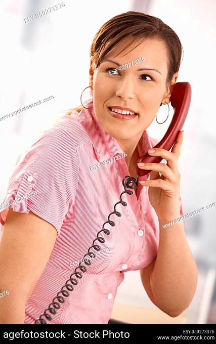 Closeup portrait of casual businesswoman talking on phone, smiling