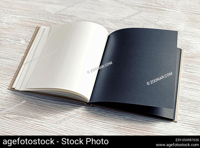 Mockup of opened blank booklet on light wooden background. Responsive design template