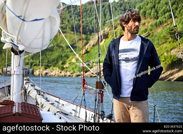 Young man with sailor clothes, Sailboat, Port of Pasaia, Gipuzkoa, Basque Country, Spain, Europe