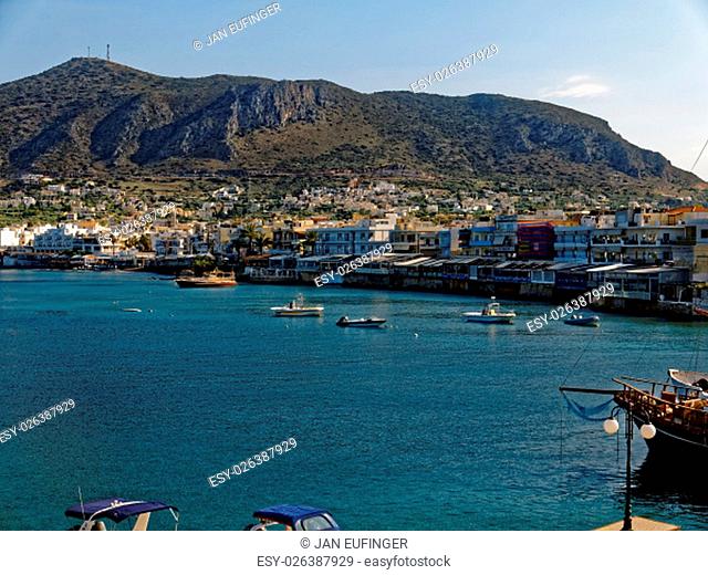 Hersonissos harbor with the town and a mountain in the background