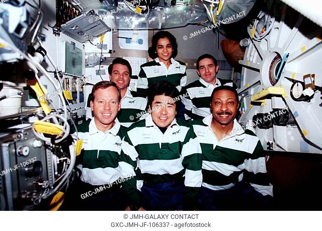 On the Space Shuttle Columbia's middeck, the crewmembers for the mission pose for the traditional in-flight portrait. In front, left to right