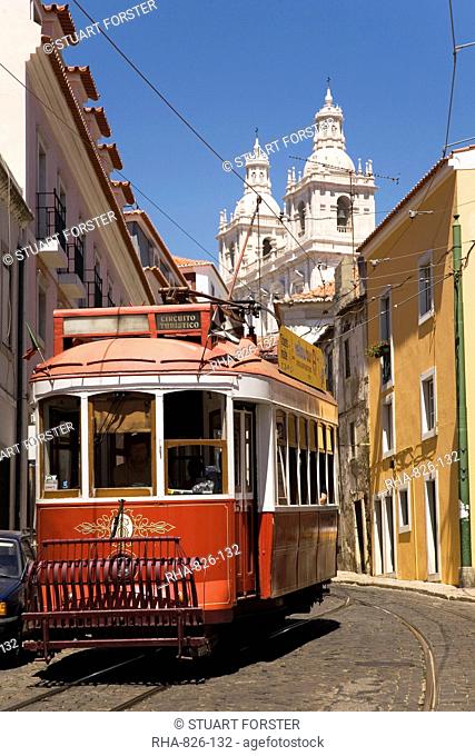 A tram runs along the tourist friendly Number 28 route in Alfama, Lisbon, Portugal, Europe