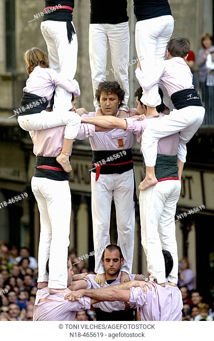 'Castellers' building human towers, a Catalan tradition. Girona, Catalonia, Spain