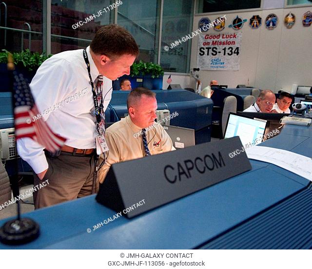 Astronauts Terry Virts (left) and Barry Wilmore, both STS-134 spacecraft communicators (CAPCOM), are pictured at their console in the space shuttle flight...