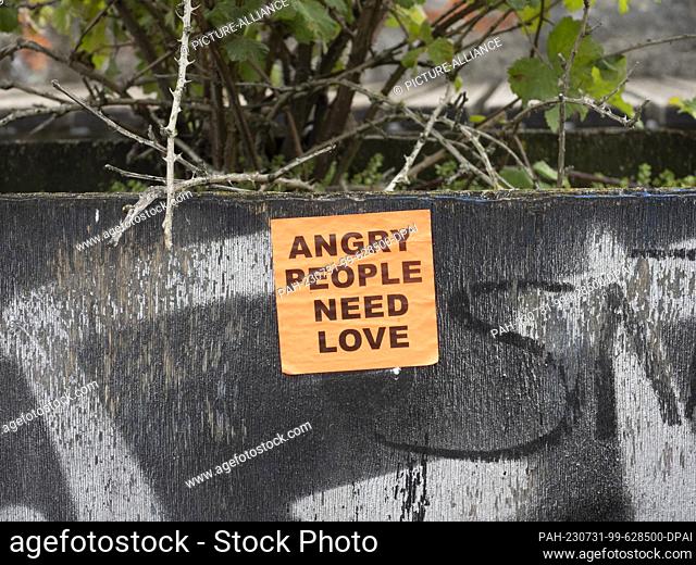 31 July 2023, Berlin: A sticker is seen in Görlitzer Park. The green space in Kreuzberg causes discussions again and again