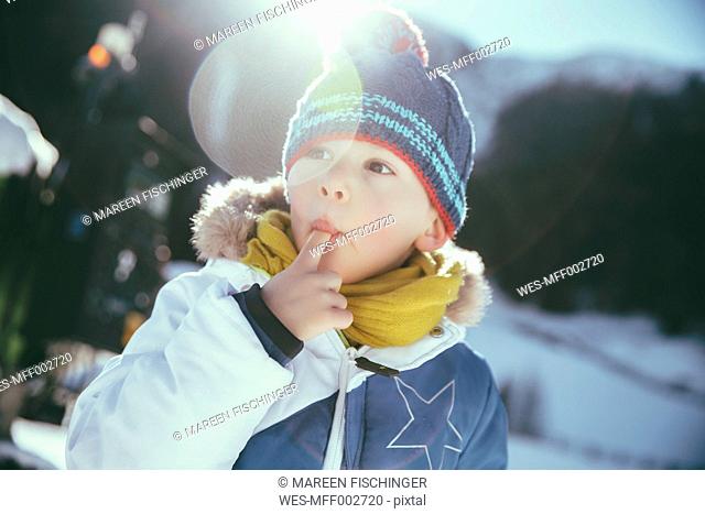 Italy, Val Venosta, Slingia, boy eating snow