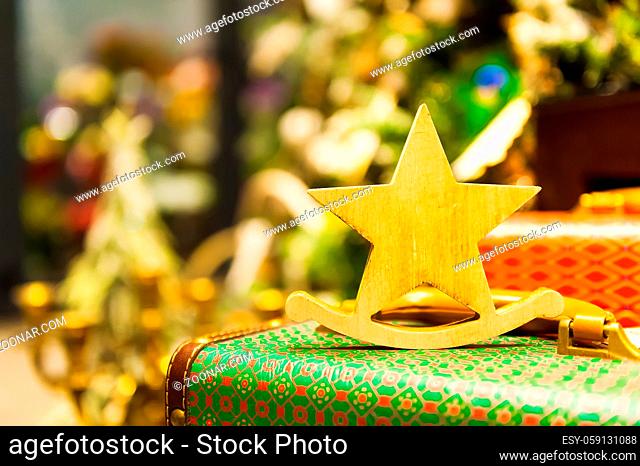 Christmas Fir Tree Toys Old wooden star It stands on an retro suitcase Burning Candles, Boxes, Balls, Pine Cones, Walnuts