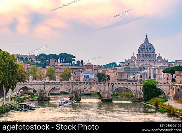 Sunset view of St. Peter's Basilica, Ponte Sant'Angelo, and Tiber River in Rome, Italy