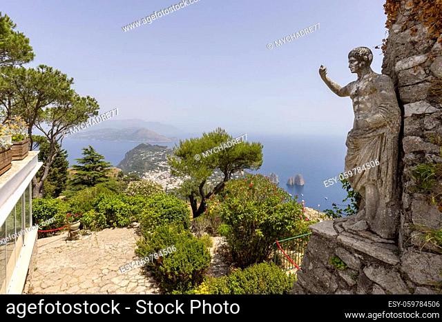 Capri Island; Italy - June 28; 2021: Aerial view from the top of the island Monte Solaro to the Tyrrhenian Sea with rocks Faraglioni; statue of Emperor Augustus...