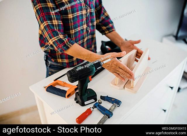Woman working with wood and tool at home