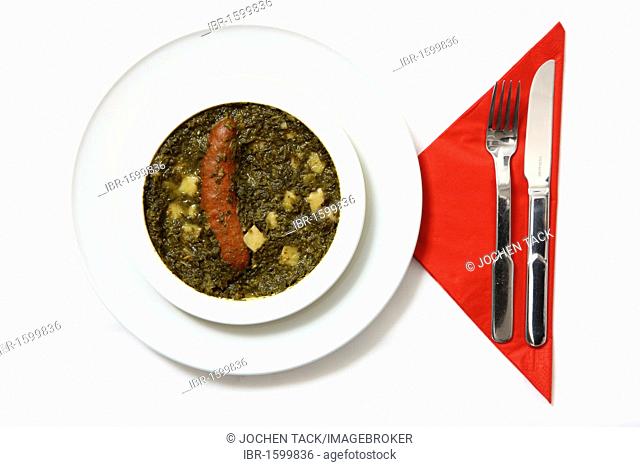 Kale with smoked sausage, pre-prepared meal, served on a plate, in the original packaging