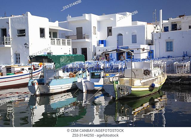 Whitewashed houses and traditional boats at the small harbour in Naoussa village, Paros Island, Cyclades Islands, Greek Islands, Greece, Europe