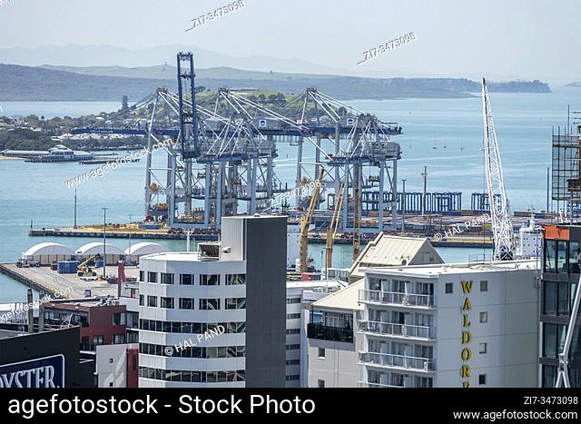AUCKLAND, NEW ZEALAND - November 05 2019: cityscape from above of big harbor cranes and high buildings at cool downtown of dynamic city