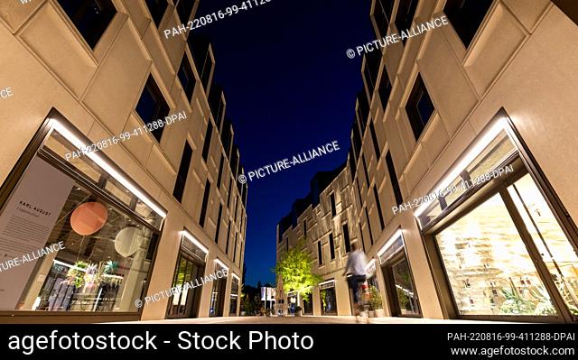 16 August 2022, Bavaria, Nuremberg: Dark blue is the evening sky at the blue hour above the buildings on the site ""Augustinerhof""