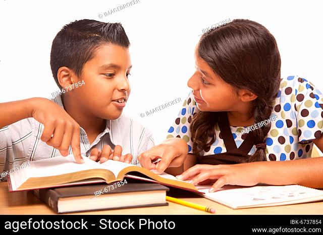 Hispanic brother and sister having fun studying together isolated on a white background