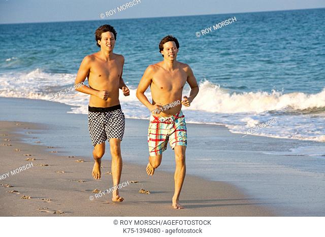 Twins running on the beach