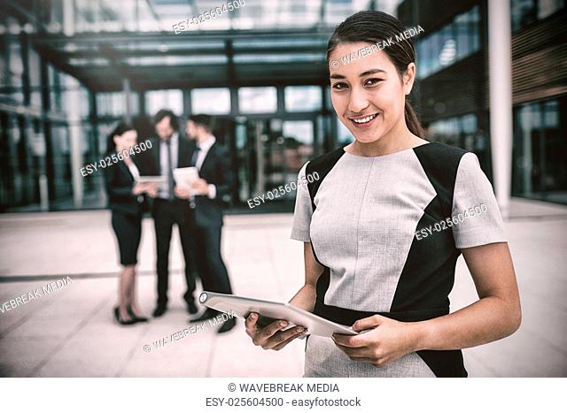 Portrait of businesswoman holding digital tablet