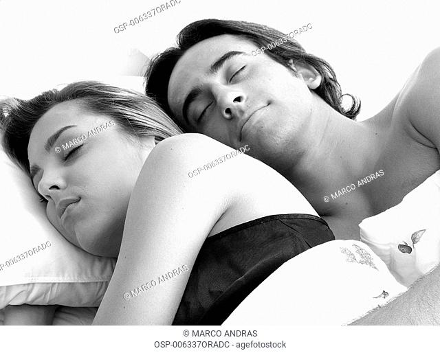 a couple sleeping hugged