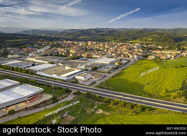 Aerial view of the town of NavÃ s and the Mujal greenway between spring fields (Bages, Barcelona, Catalonia, Spain)
