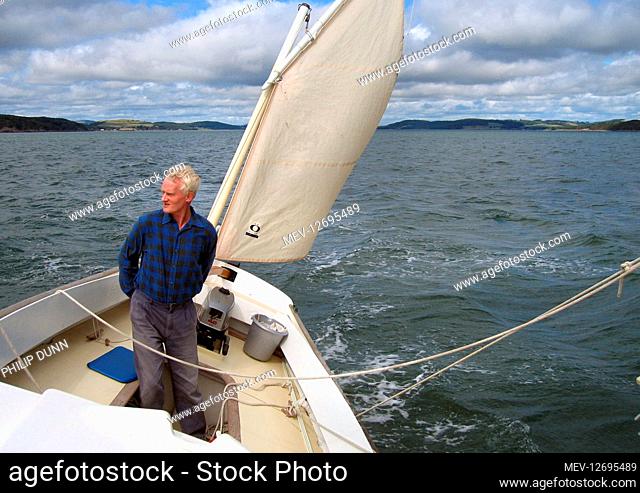 Historian and author, David R Collin, sailing his boat in Kirkcudbright Bay, SW Scotland. In 1960, David and his father discovered the body of lighthouse keeper...