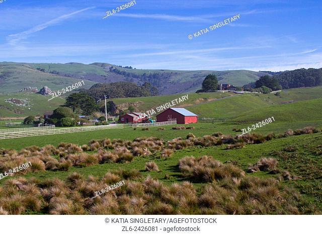 Beautiful red house in the middle of nowhere along California highway one coastal road and coastal scenic highway along Pacific Ocean on California west coast