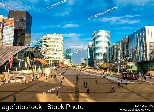 France. Paris. La Defense. The beginning of the summer evening. Many people on the pedestrian square
