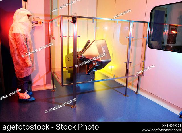Laboratory technician equipped with Security Suit inside a technology lab photographed with spectacular lighths