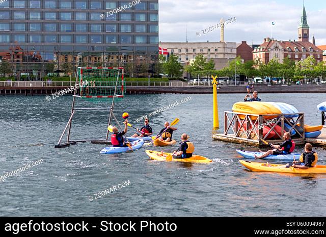 Copenhagen, Denmark - June 20, 2017: Group f men playing kayak polo in Copenhagen harbor