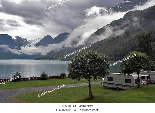 Camping by the mountain lake with mountains and glacier at background