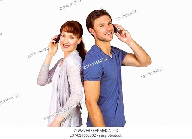 Couple both making phone calls
