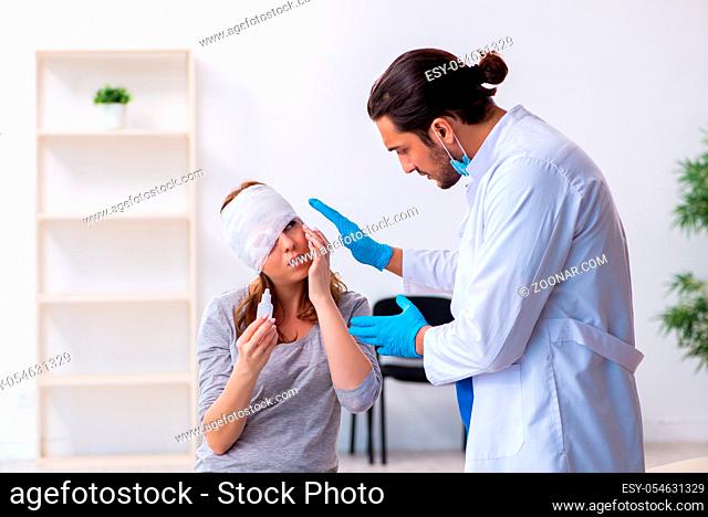 Young injured woman visiting young male doctor