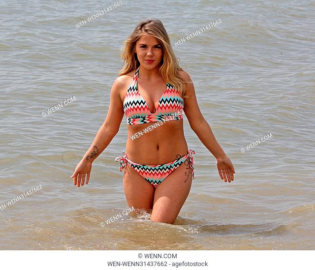 Siobhan Graves, 25, from Leigh on Sea in Essex enjoys the spring sunshine with a dip in the sea at Chalkwell Beach, Essex earlier today