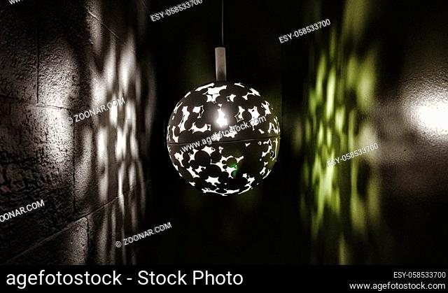 low lit decorative lamp in a hall with a green wall in bath somerset uk