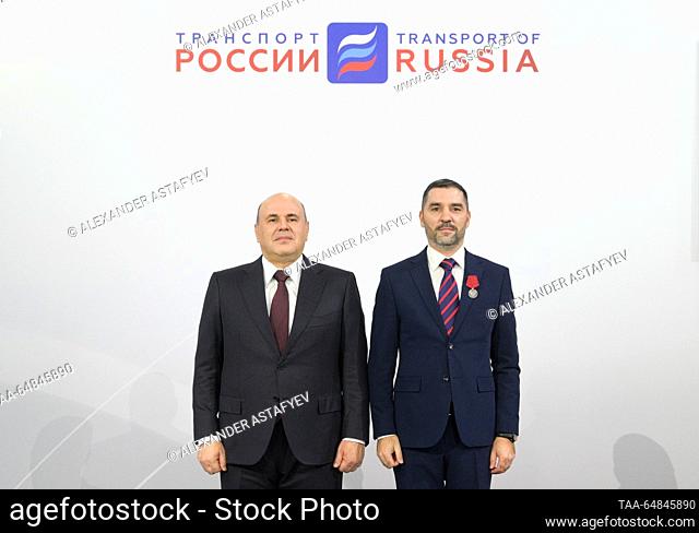RUSSIA, MOSCOW - NOVEMBER 15, 2023: Russia's Prime Minister Mikhail Mishustin (L) presents Avtodor-Engineerin chief specialist Pavel Mantrov with Russia's Order...