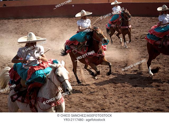 "Escaramuzas ride their horses in an Escaramuza fair in the Lienzo Charros el Penon, Mexico City, Sunday, January 19, 2013