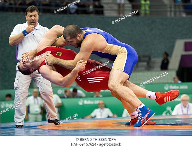 Germanys Oliver Hassler (red) and Islam Magomedov of Russia compete in the men's 98kg Greco-Roman wrestling qualification in Baku, Azerbaijan, 13 June 2015