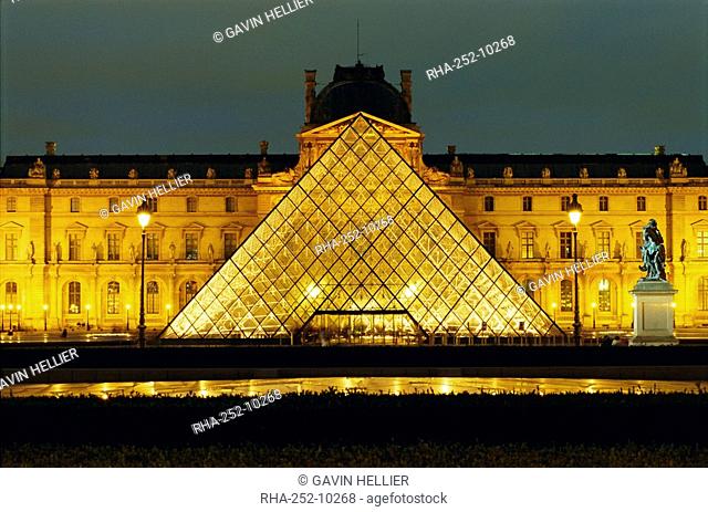 The Louvre and pyramid illuminated at night, Paris, France, Europe