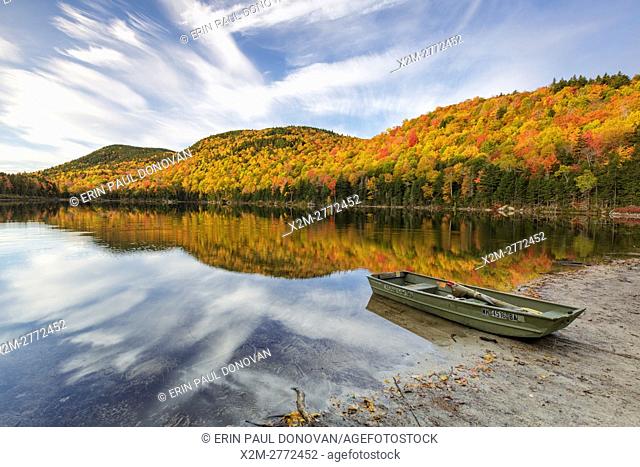Reflection of autumn foliage in Upper Hall Pond in Sandwich, New Hampshire USA during the autumn months