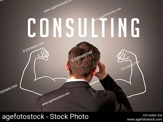 Rear view of a businessman with CONSULTING inscription, powerfull business concept