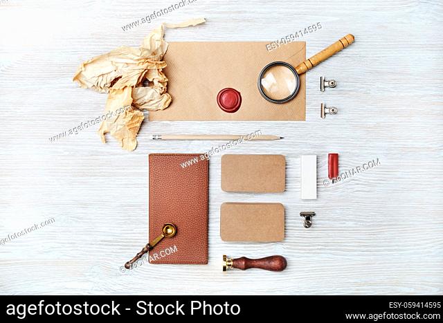 Photo of blank vintage stationery on light wood table background. Space for text. Flat lay