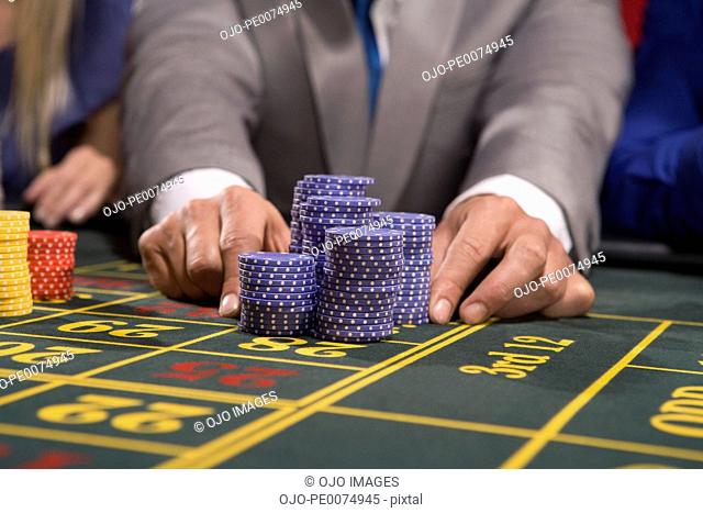 Man placing bet with gambling chips
