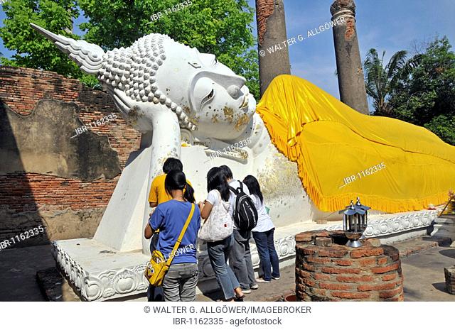 Lying Buddha statue decorated with gold leaf and ornate tunics, transition to Nirvana, Wihan Phraphutthasaiyat, Wat Yai Chai Mongkon, Ayutthaya, Thailand, Asia
