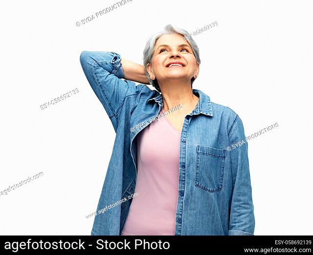 portrait of smiling senior woman in denim shirt
