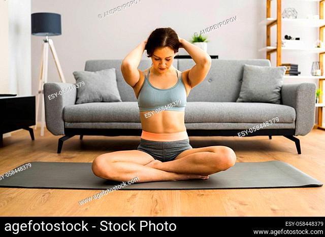 Young Woman In Fitness Wear Doing Exercise At Home