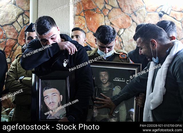 28 March 2022, Israel, Kisra-Sumei: Relatives and colleagues mourn during the funeral of Israeli border policeman Yezen Falah at Kisra-Sumei village