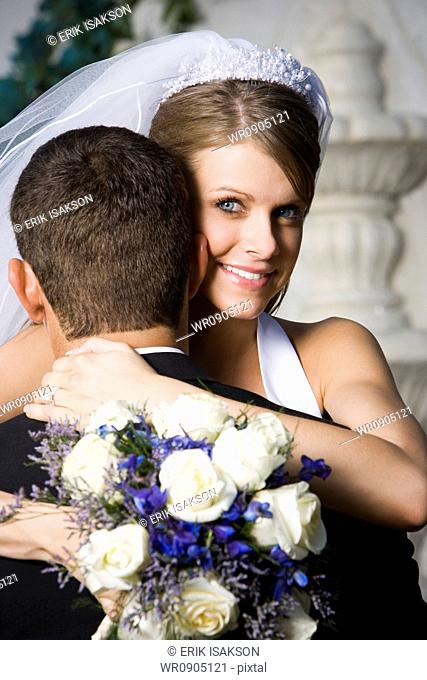Portrait of a newlywed couple embracing