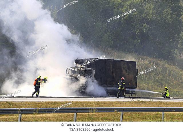 SALO, FINLAND - AUGUST 17, 2018: Firefighters extinguish vehicle fire on E18 in Salo. Delivery truck is completely destroyed in fire
