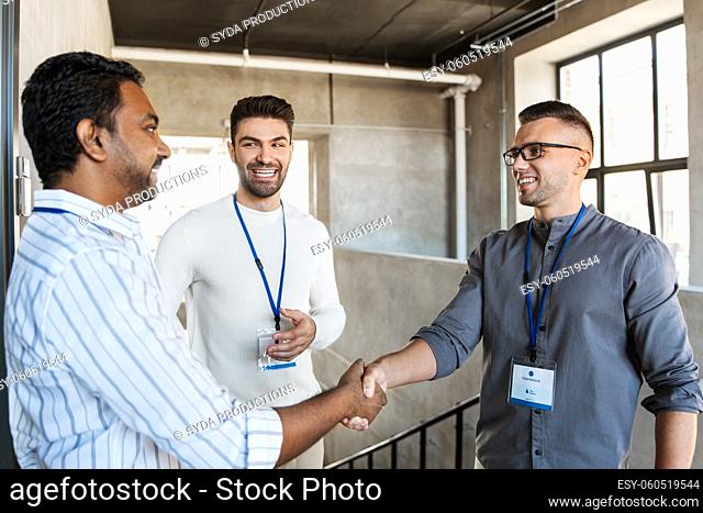 happy businessmen making handshake at office