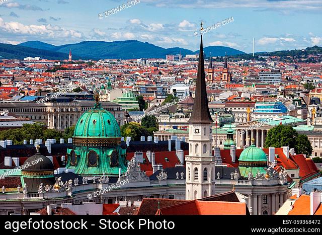 Austria, Vienna, capital city cityscape with dome of Hofburg Palace and tower of St. Michael's Church (Michaelerkirche)